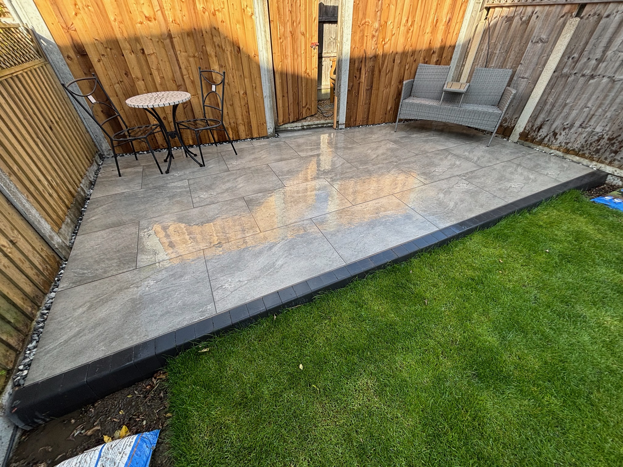 Earthcore Grey Porcelain Patio with Turf finished photo 2
